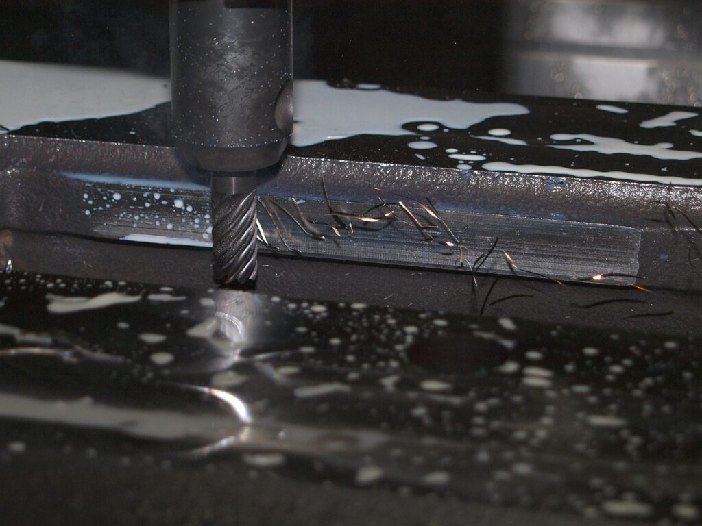CNC machine generates dust while removing material to form a part.