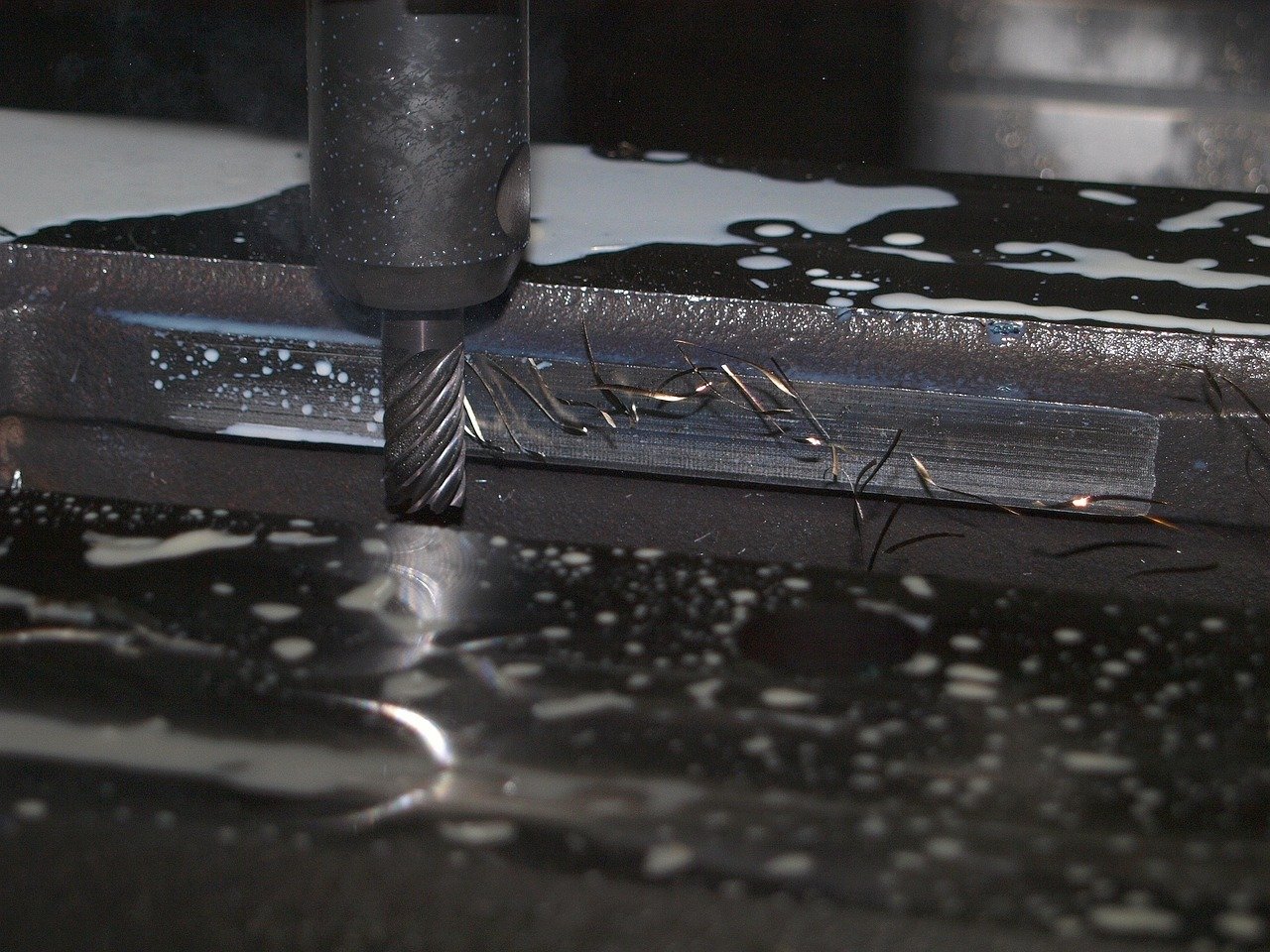 CNC machine generates dust while removing material to form a part.